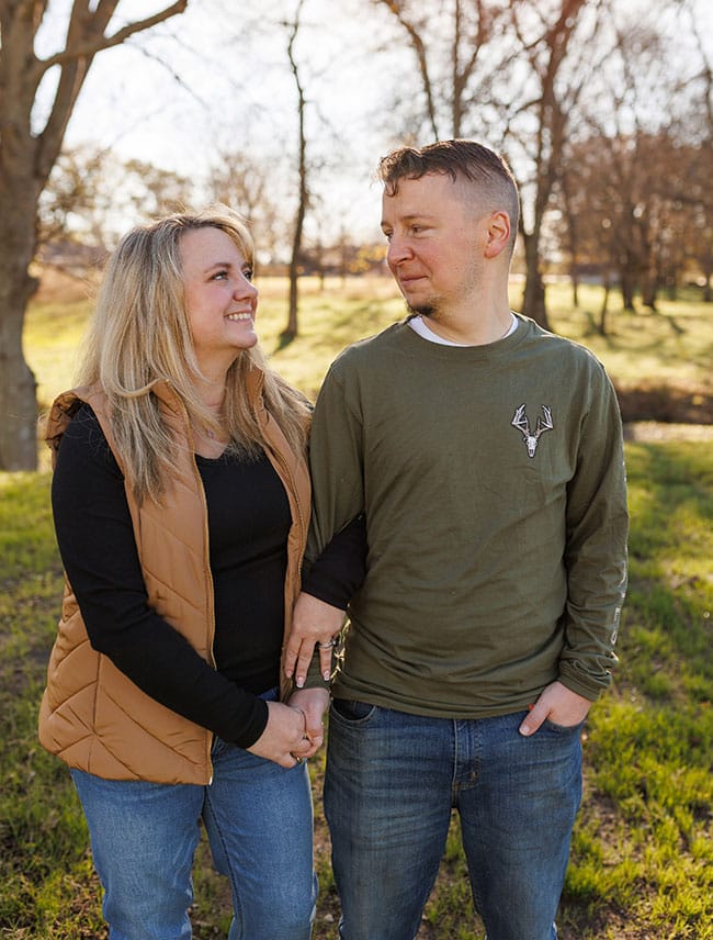 loving hopeful adoptive parents enjoy a walk in the woods together